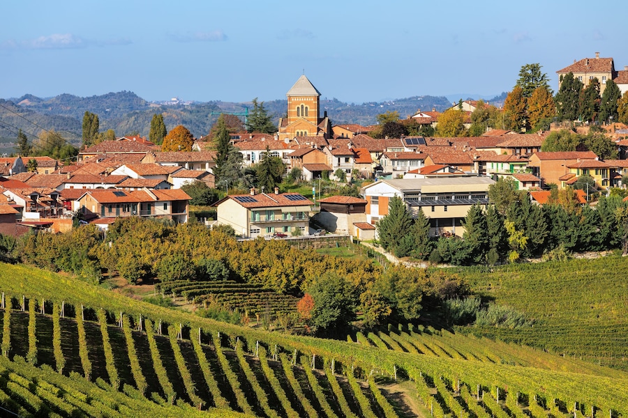 Small town and autumnal vineyards in Piedmont, Italy.