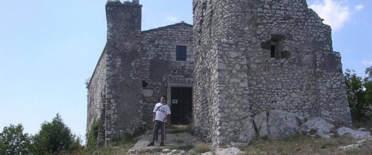 A stone castle with a person standing in front.