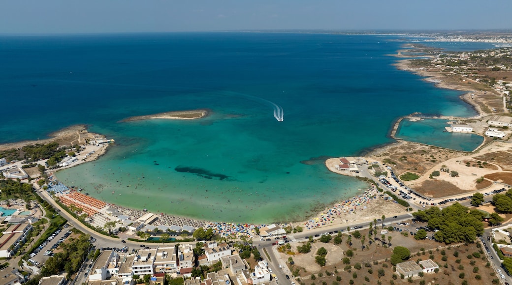 Aerial view of Sant' Isidoro beach in the province of Lecce in Salento, Puglia, Italy. In the background there is the small island of Sant' Isidoro in the middle of the clean and crystalline sea