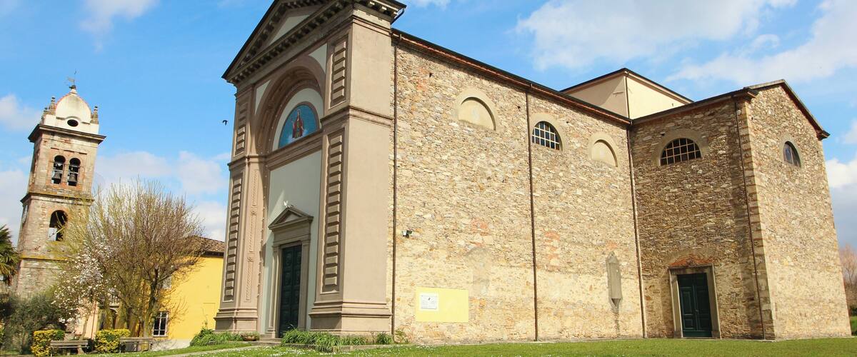 A historic church with a bell tower and a stone facade.