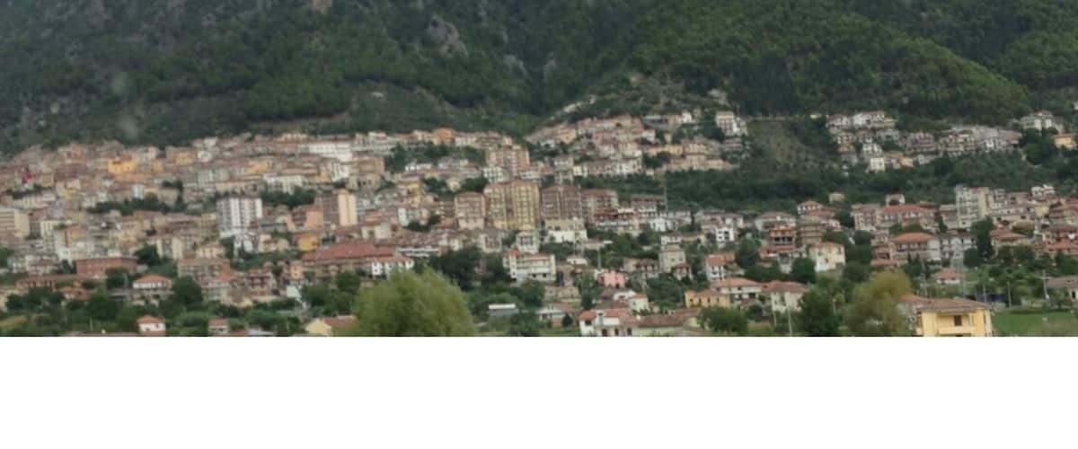 A mountainous landscape with a densely built town in the foreground.