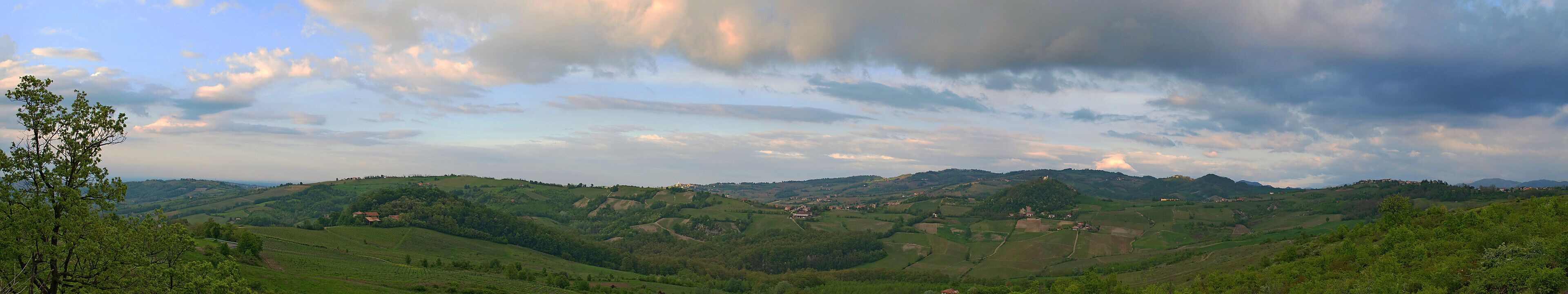 Rolling hills, a valley, and scattered buildings.