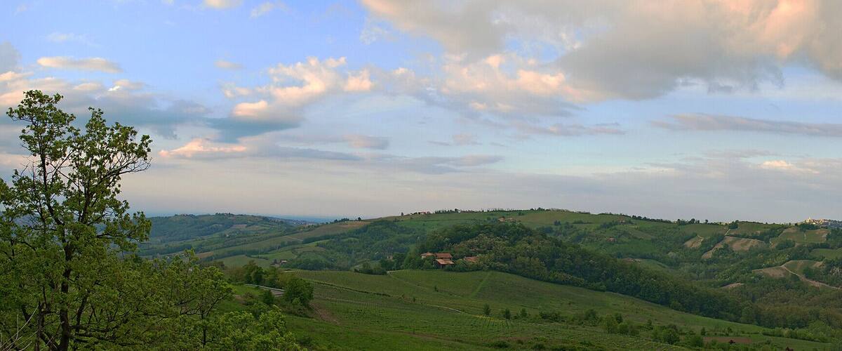 Rolling hills, a valley, and scattered buildings.
