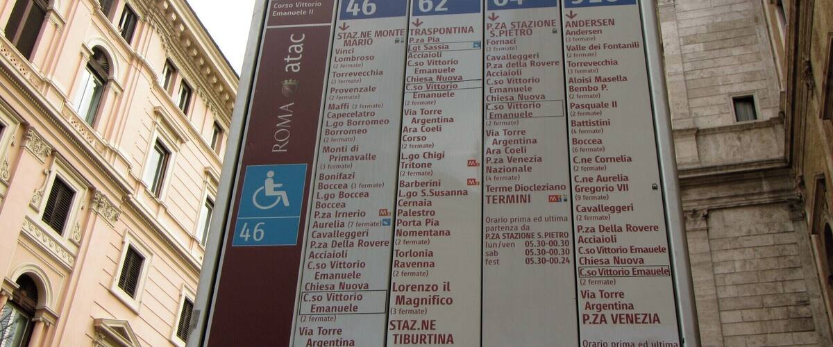 A bus stop sign with multiple bus routes and destinations.