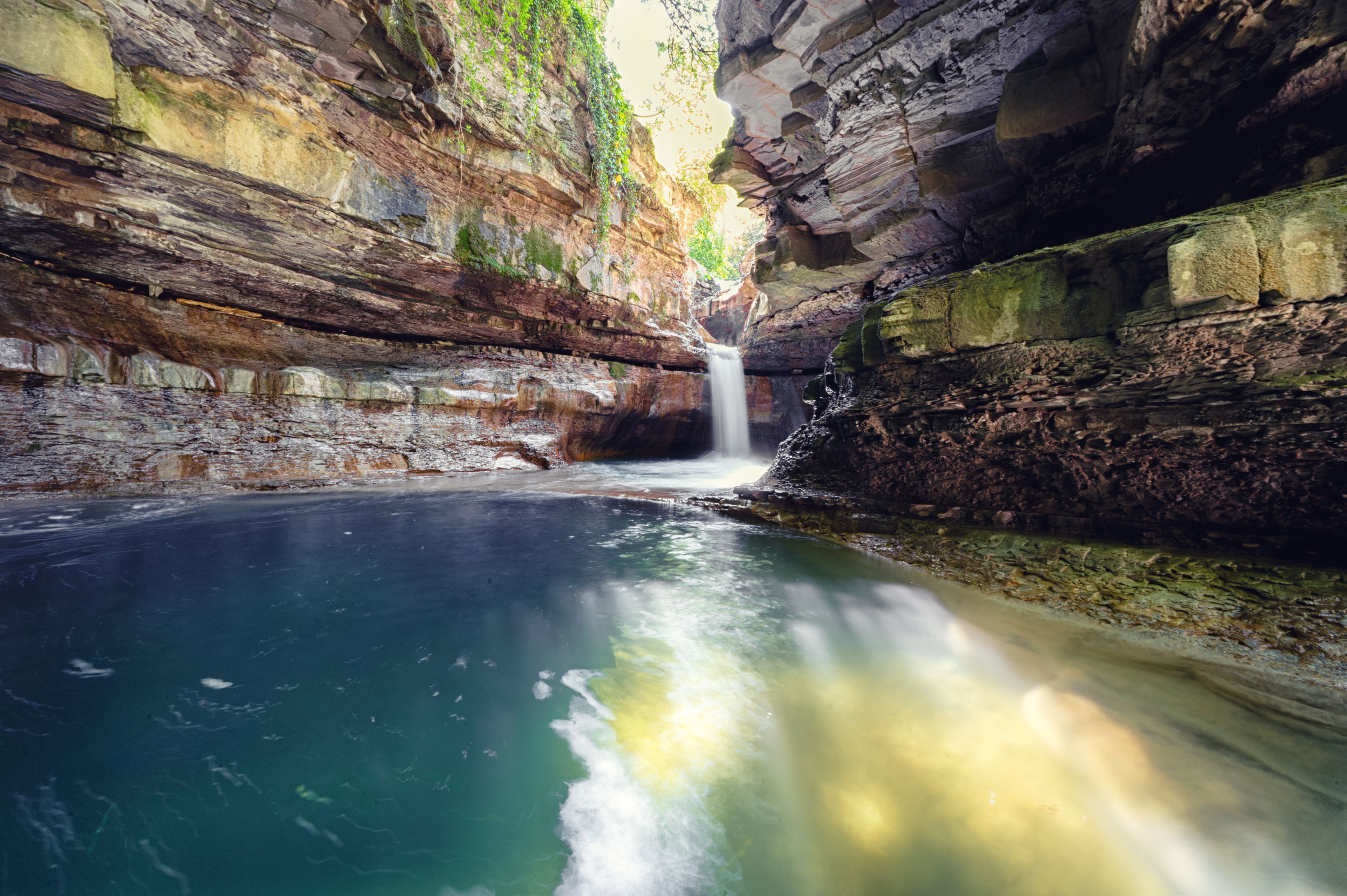 Italy, 2 June 2022. Wonderful waterfall in Premilcuore surrounded by nature with rocks, in long exposure.