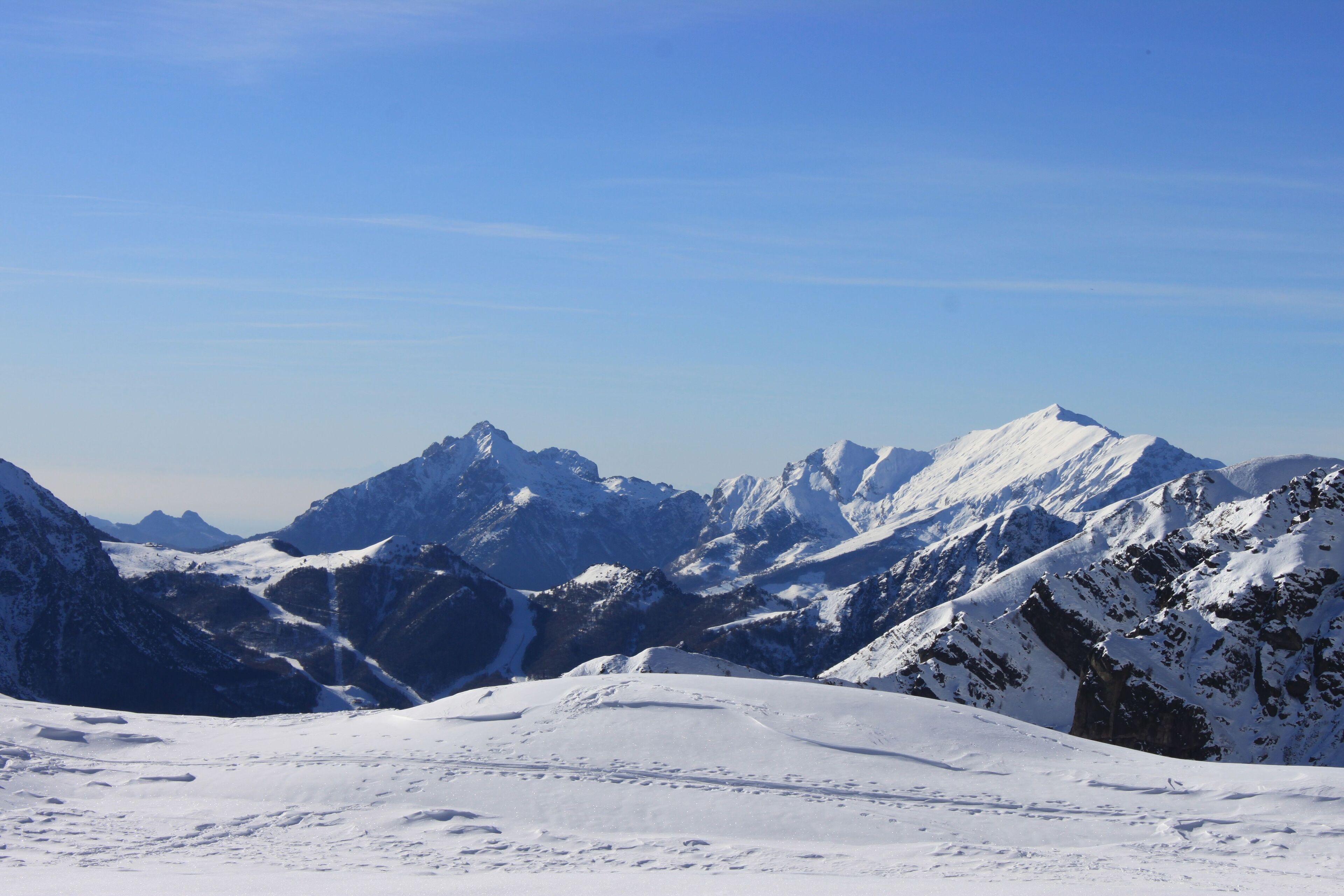 A snow-covered mountain range with clear skies.