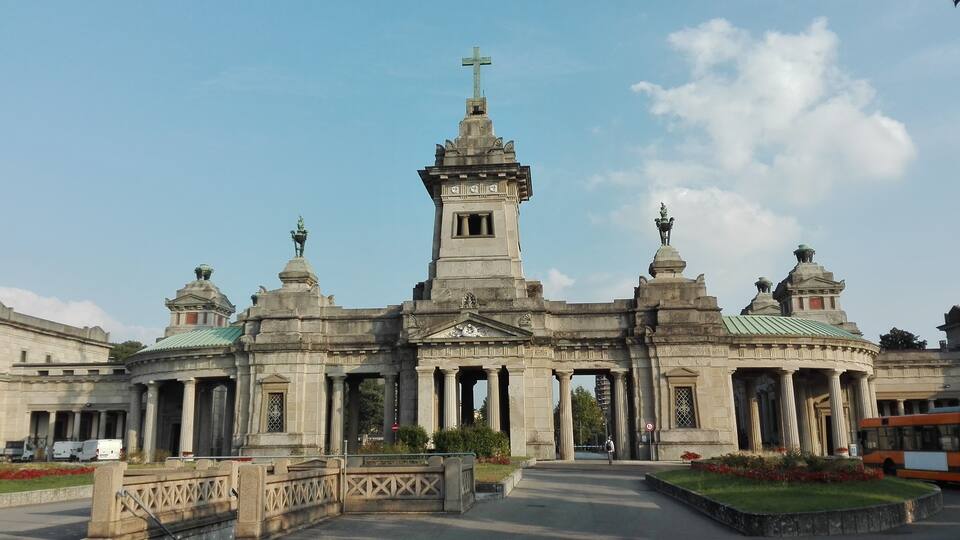 A grand church with a tall bell tower and ornate domes.