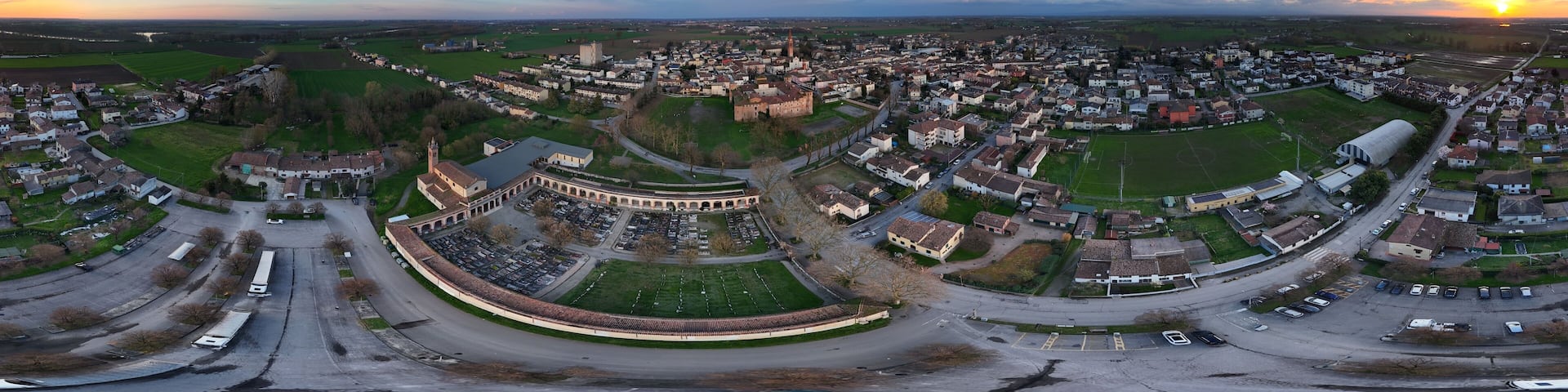 Rocca Casali Pallavicino dominating Monticelli d'Ongina at sunset, panoramic aerial view