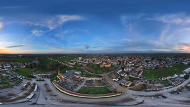 Rocca Casali Pallavicino dominating Monticelli d'Ongina at sunset, panoramic aerial view