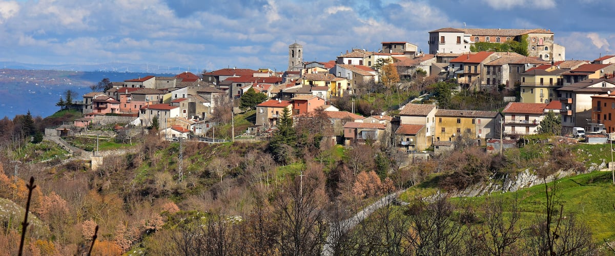 A hillside village with colorful buildings and a church.