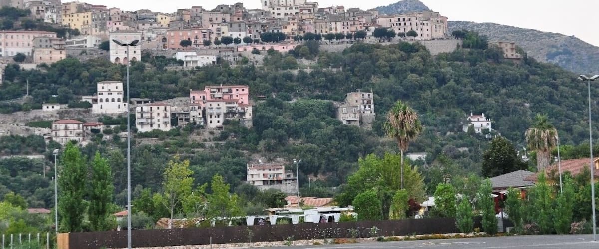 A hillside town with buildings and a prominent church.