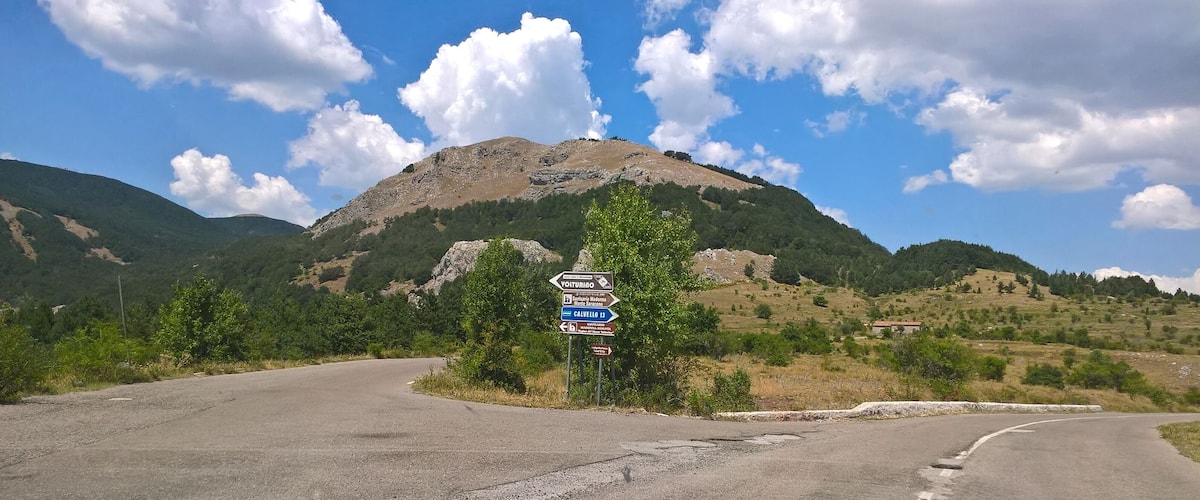 A mountain road with directional signs for Volturino, San Marino, and Calvelo 15.