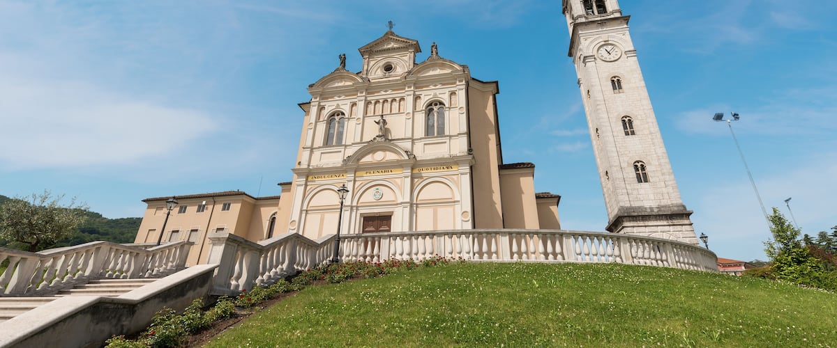 A historic church with a bell tower and a staircase leading up to it.