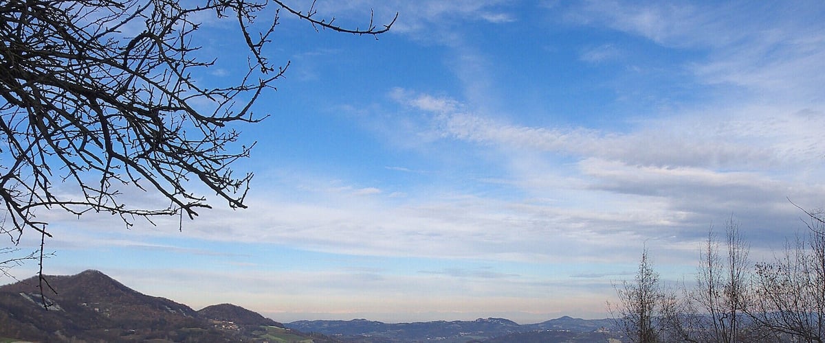 A mountainous landscape with scattered houses and clear skies.