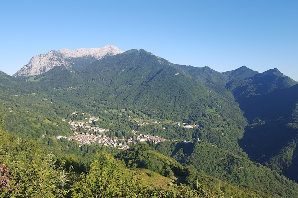 A mountainous landscape with a small town nestled in the valley.