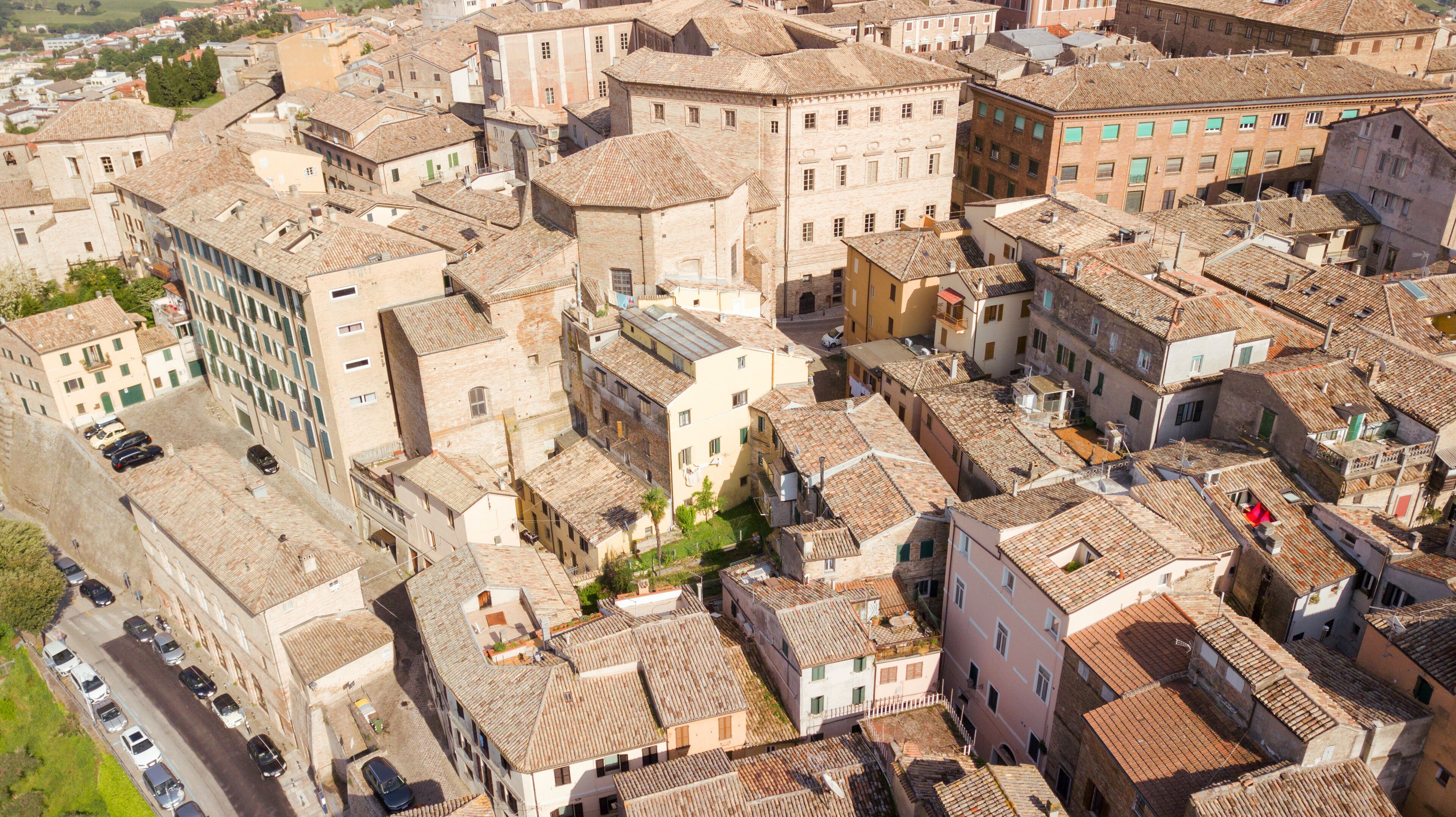 An aerial view of a densely packed historic town with narrow streets and closely built buildings.