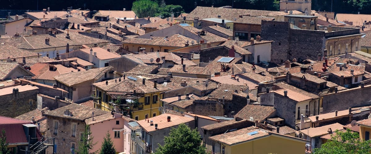 A densely packed town with historic buildings and a church tower.