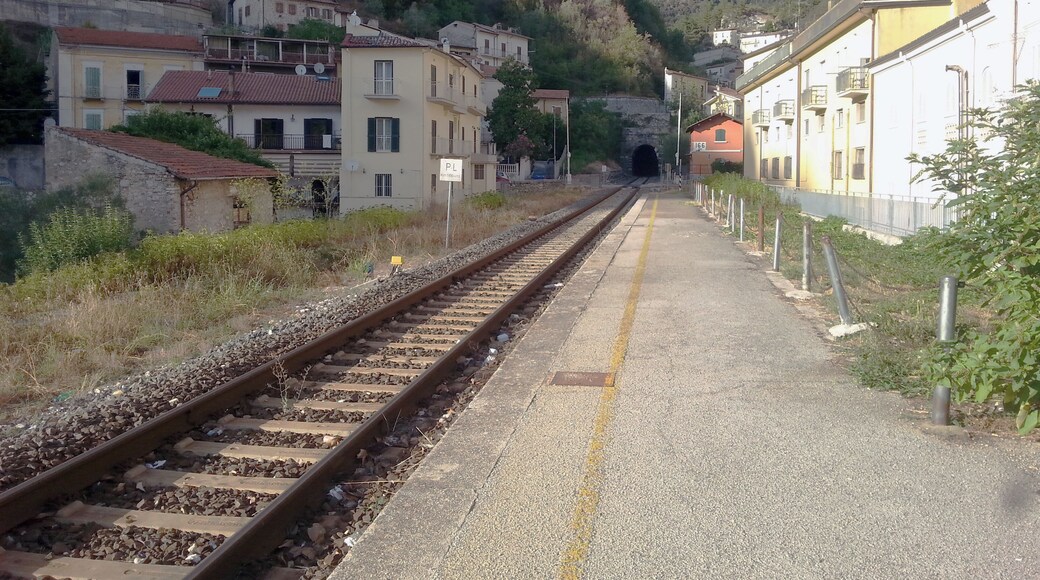 Antrodoco Centro railway stop (province of Rieti, central Italy), on the Terni-Rieti-L'Aquila-Sulmona line. View of the tracks heading to L'Aquila with the level crossing and the portal of the Castello rail tunnel.