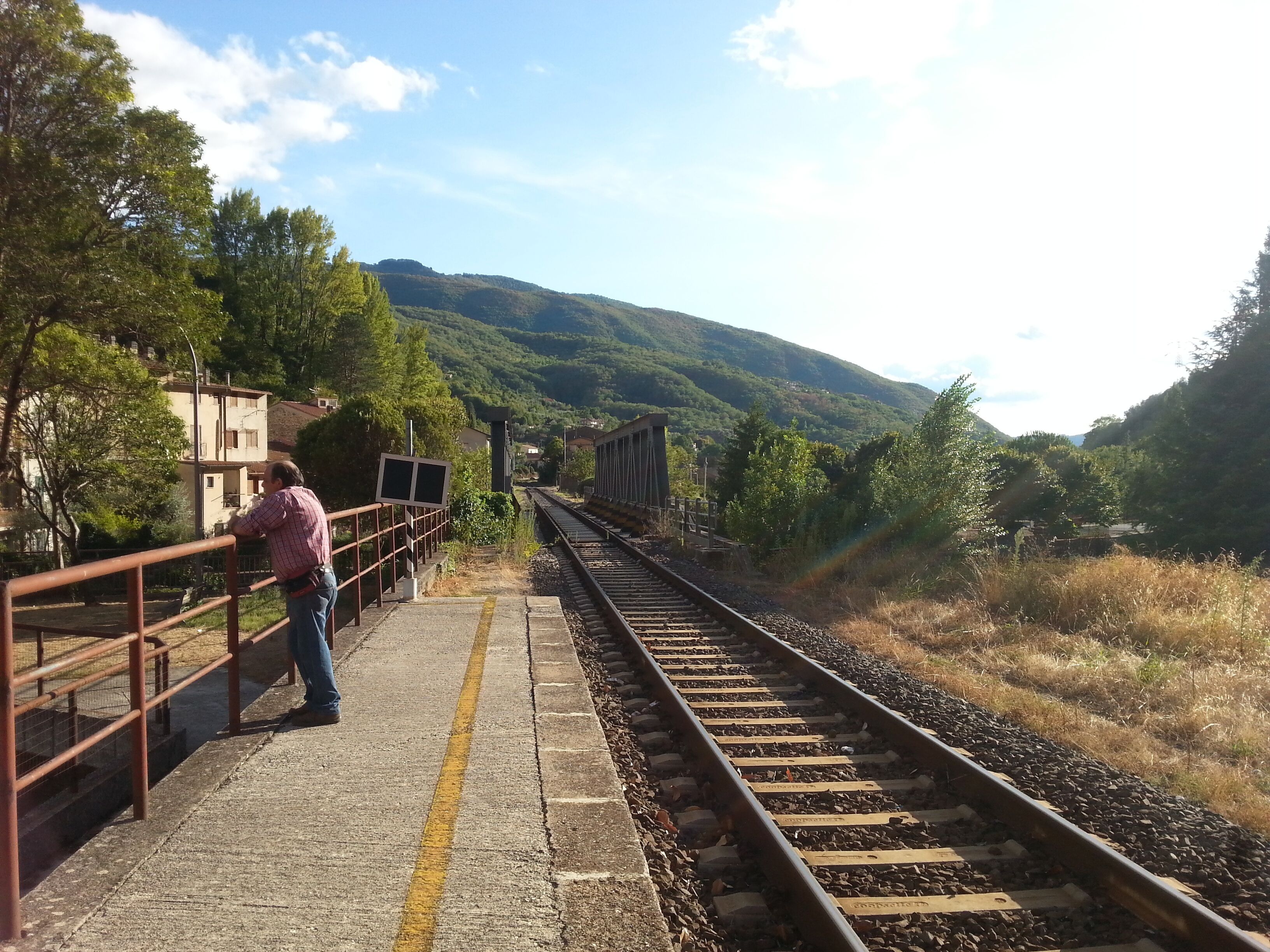 Antrodoco Centro railway stop (province of Rieti, central Italy), on the Terni-Rieti-L'Aquila-Sulmona line. View of the tracks heading to Terni with the iron bridge over Velino river.