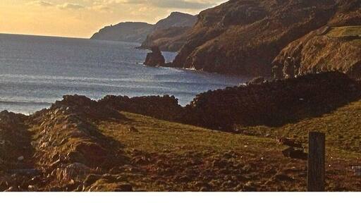 A view along a scenic Rd. West Donegal. With a old hand built stone wall along the edge of the cliff