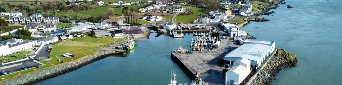 Bird's eye view of Greencastle Harbor with moored boats. Donegal, Ireland.
