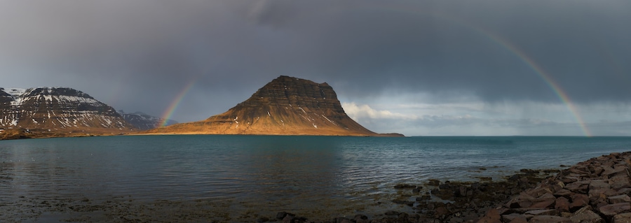 Panoramic view of Kirkjufell mountain with rainbow 2025