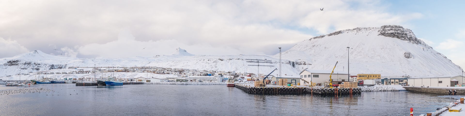 Panoramic snowy fishing town by the water