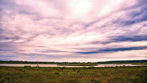 I was out on a bike ride in the morning when i rode passed this nice looking field, with the heavy cloudy sky, the woodland in the horizon and the lake in the middle of it.
So i brought up my camera which i of course brought with me so i could take a photo of it.
The beauty of this place was breathtaking. If i could i would visit it again.