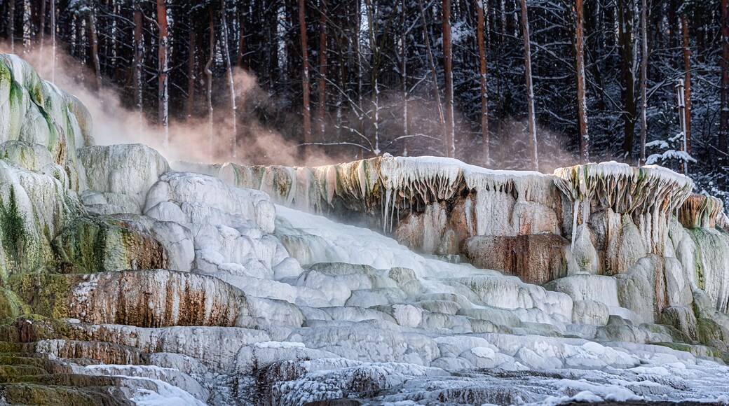 Snow covers the side of the famous Salt Hill of Egerszalók, Hungary with the upflying vapor from the hot water on its top