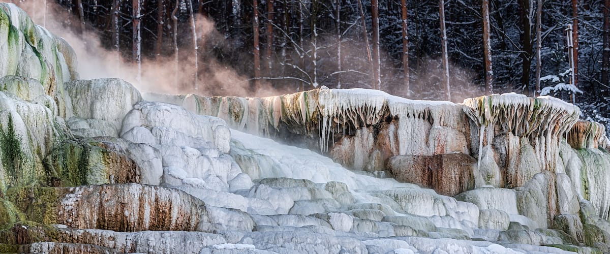 Snow covers the side of the famous Salt Hill of Egerszalók, Hungary with the upflying vapor from the hot water on its top