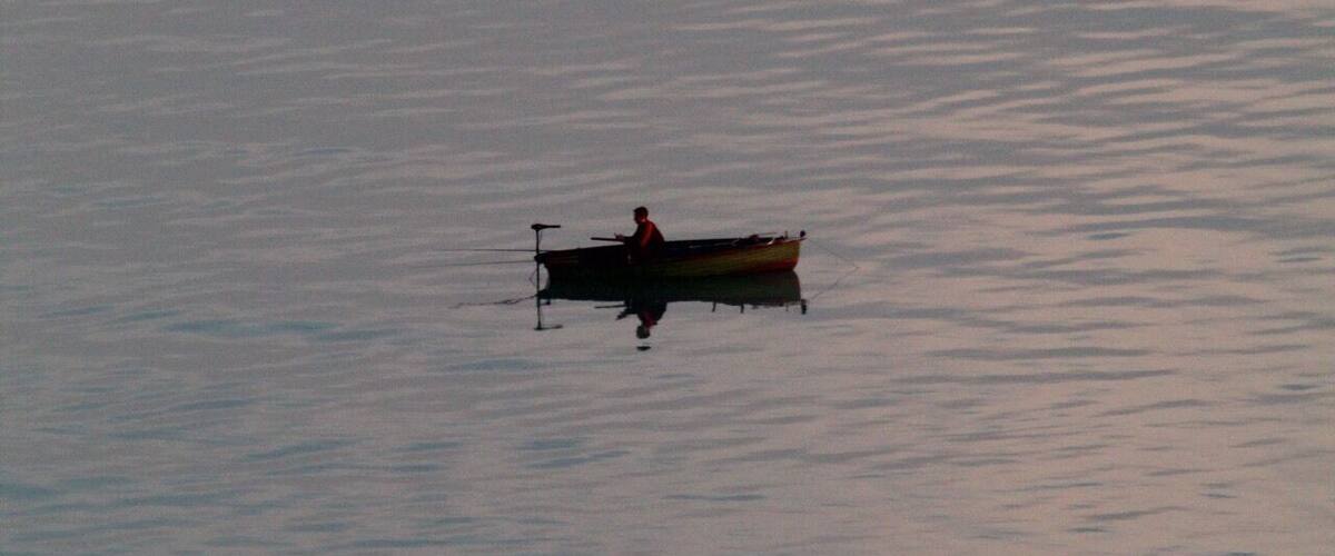 A small boat on calm water.