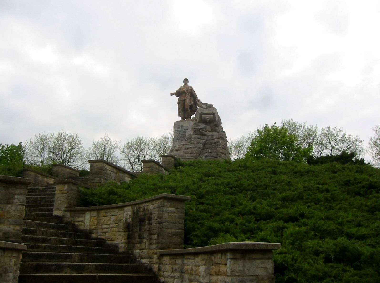 A statue on a rock with a staircase leading up to it.