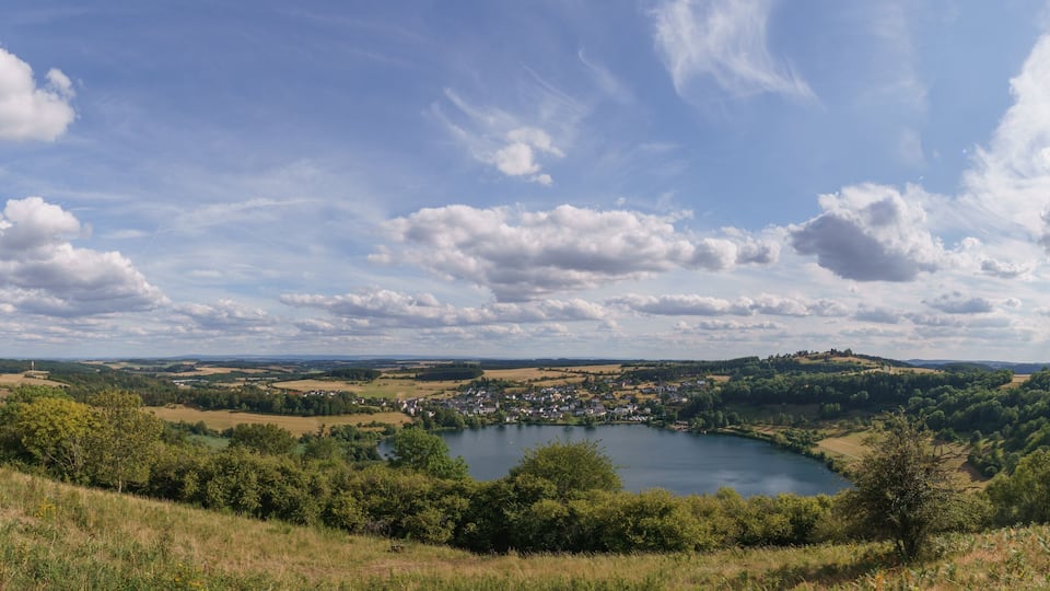 A lake surrounded by hills and a small town.