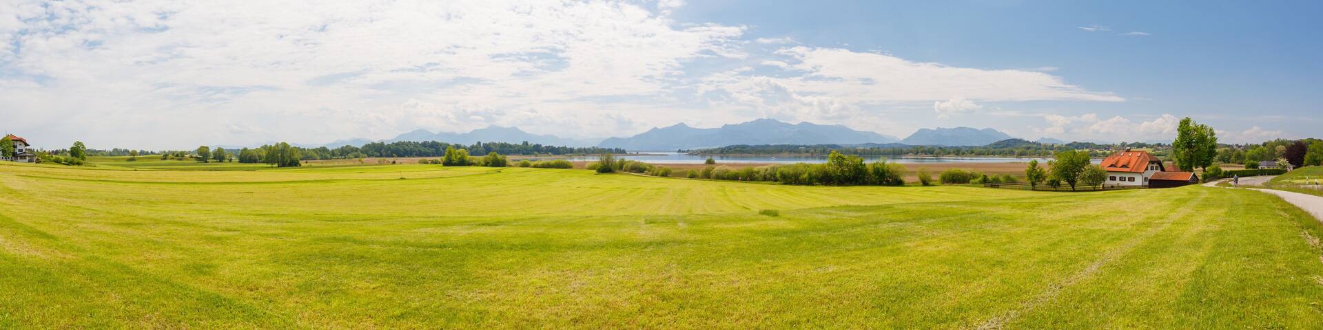 Panorama of lake Chiemsee with alps in background