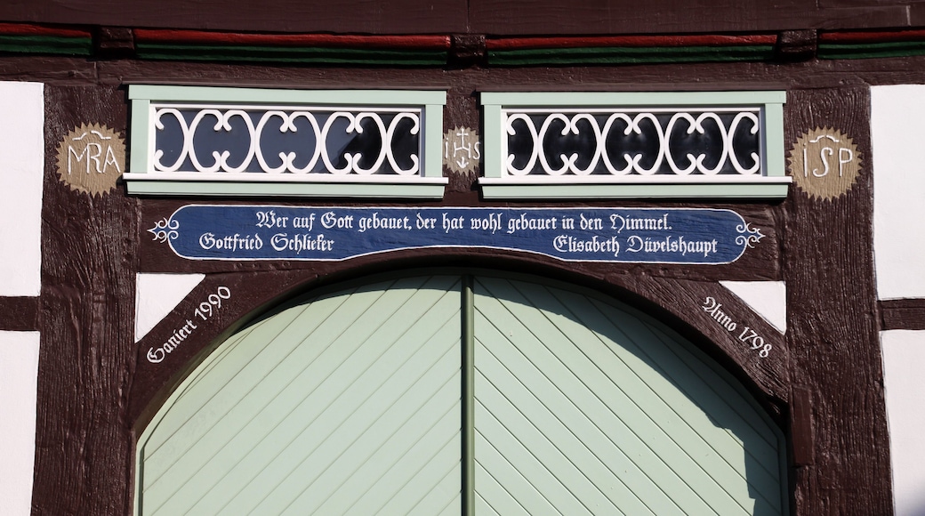 A traditional wooden door with a sign above it. The sign has the text 'MRA' and 'ISSP' on either side.