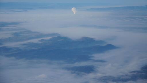 Germany, the steam of Leibstadt nuclear power plant pushing through the fog. Picture taken overhead Gailingen during an approach to Zurich.