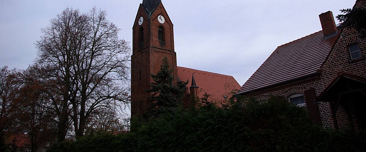 A church with a tall steeple and a clock tower.