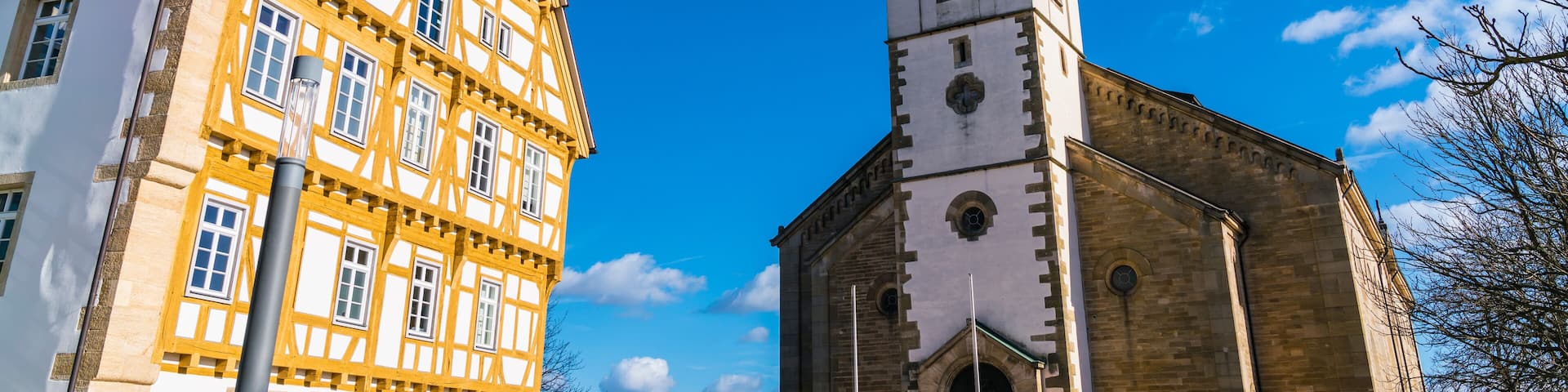 Germany, Neuhausen auf den fildern city place next to old historical church and timbered house on sunny day
