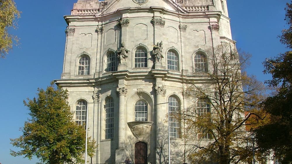 A large, historic building with a prominent dome and two towers.