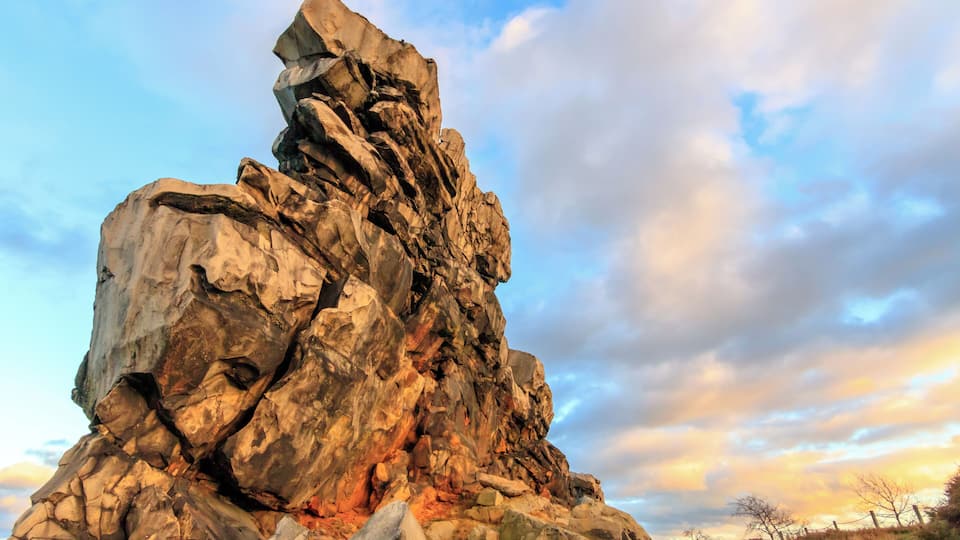 A large rock formation with a rugged, layered structure.