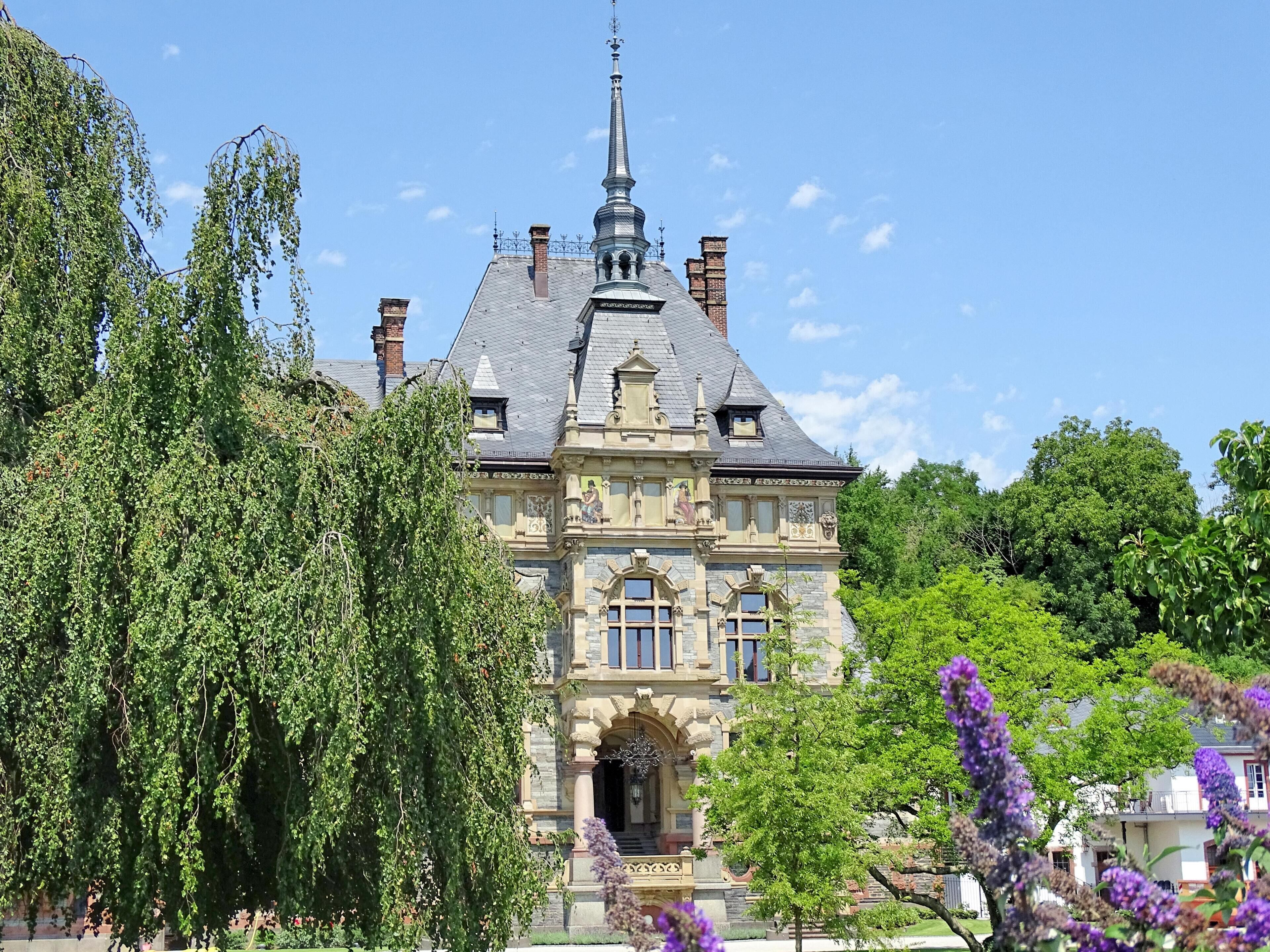 A large, historic building with a prominent tower and ornate architecture.