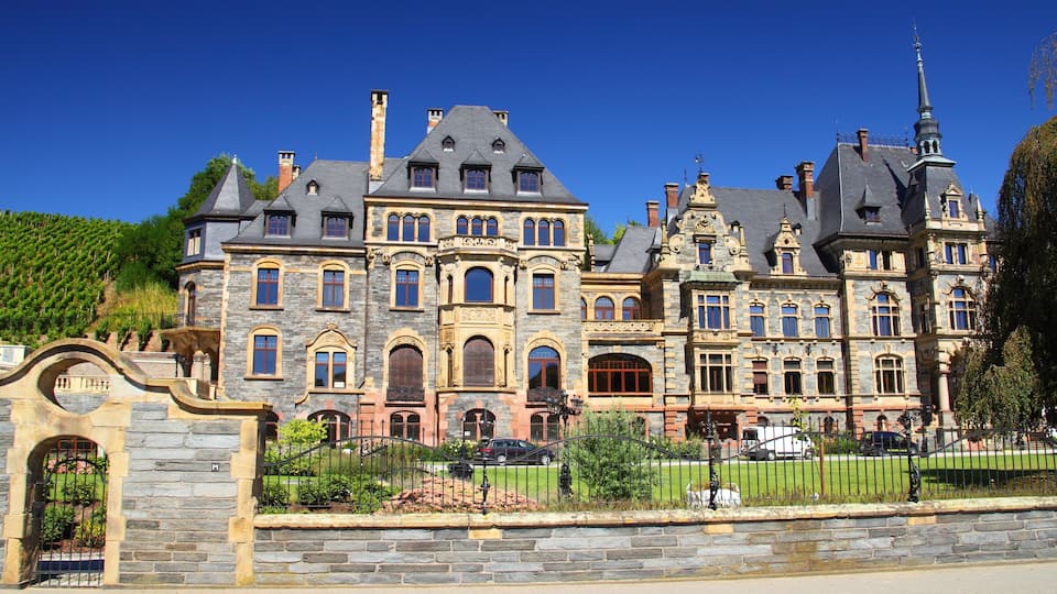 A large, ornate mansion with multiple towers and a prominent steeple.