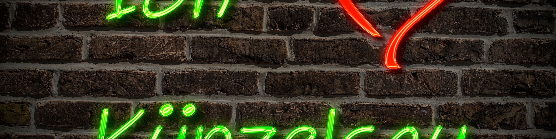 A neon sign with the text "Ich Kuinzel" and a heart shape on a brick wall.