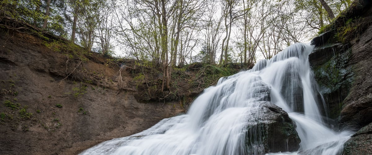 A waterfall cascading over rocks into a pool of water.