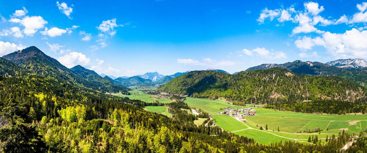 A mountainous landscape with a village nestled in a valley.