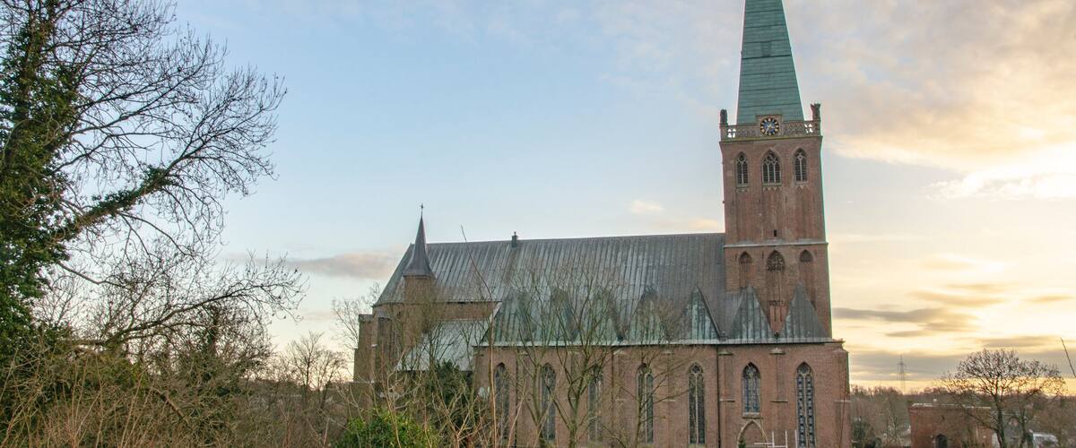 A church with a tall spire and a clock tower.