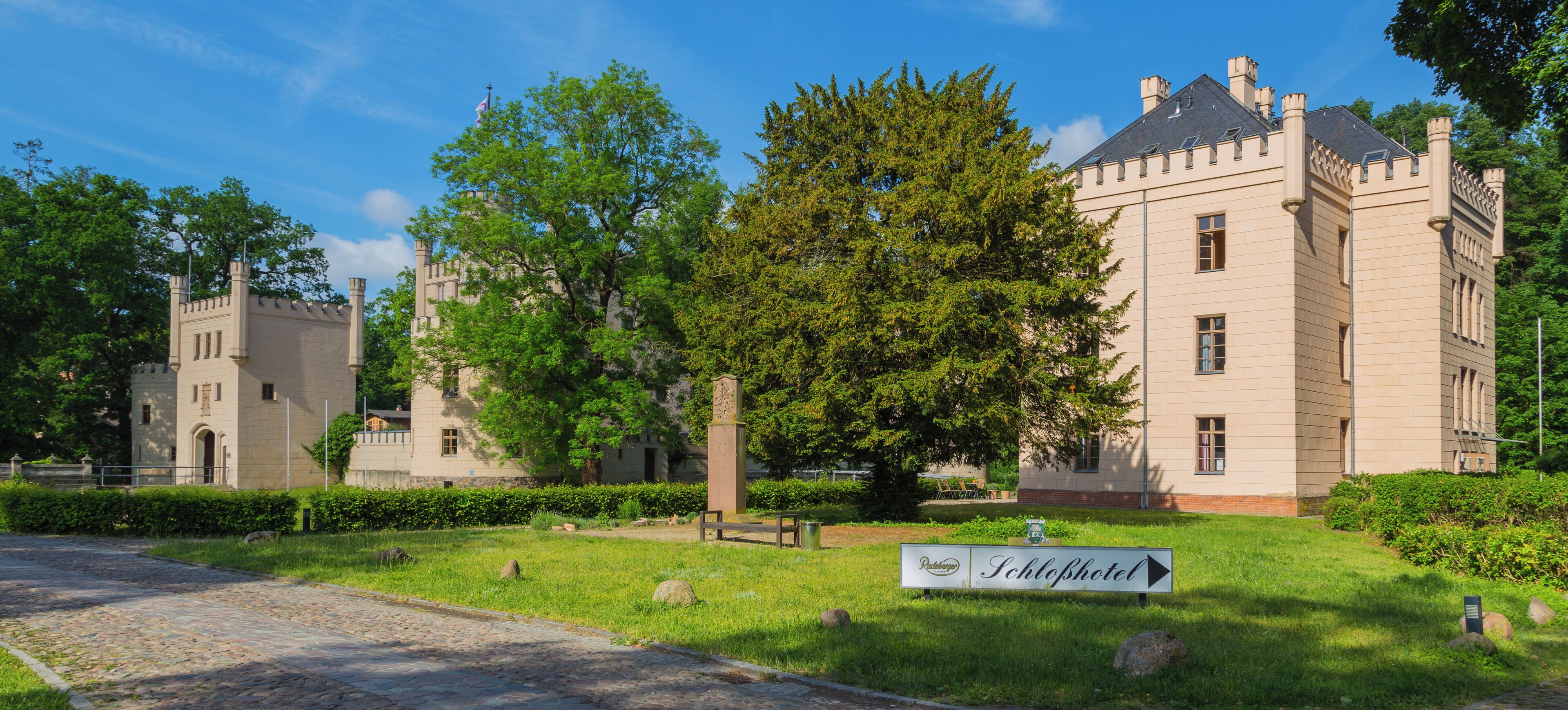 A castle-like building with a sign for 'Schloßhotel'.