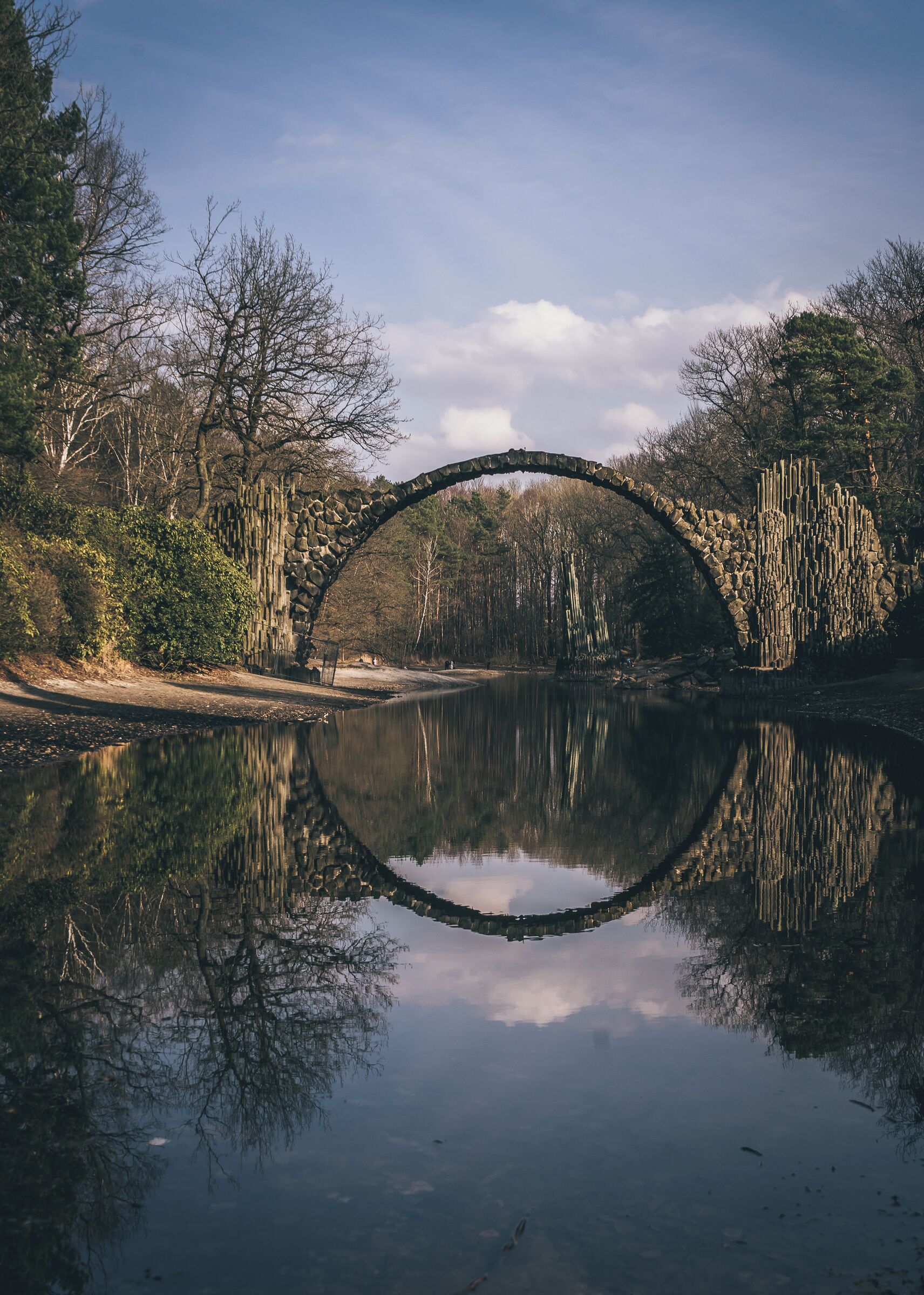 A delicately arched devil’s bridge known as the Rakotzbrücke, which was specifically built to create a circle when it is reflected in the waters beneath it. 