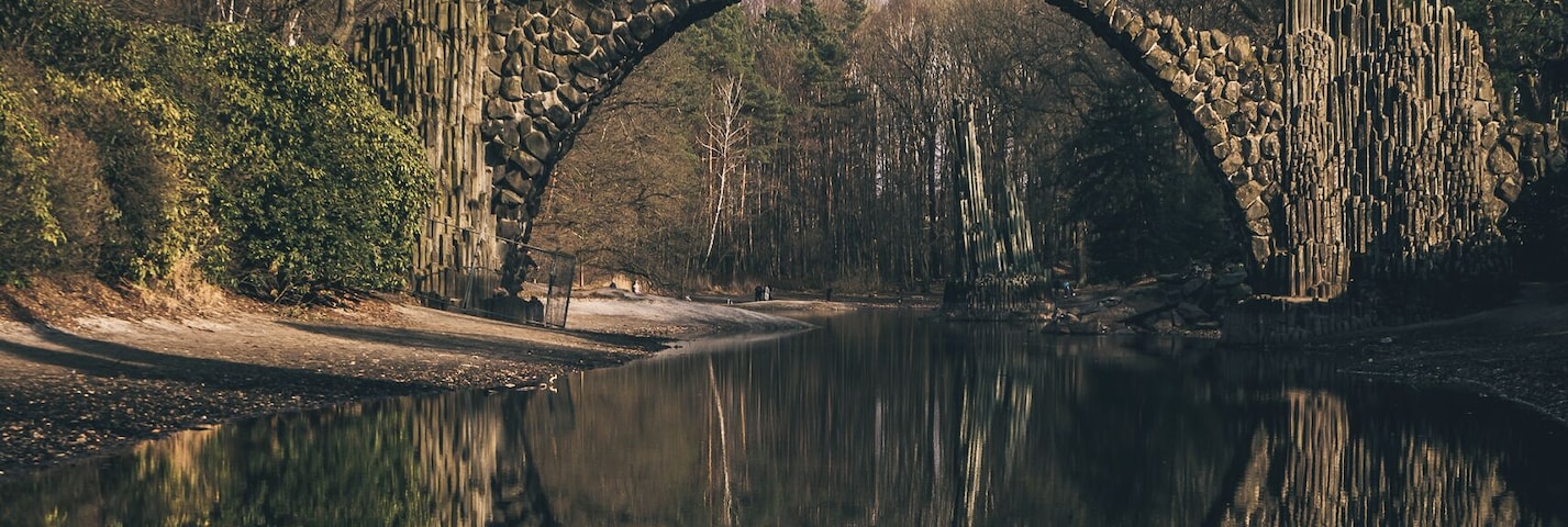 A delicately arched devilâs bridge known as the RakotzbrĂŒcke, which was specifically built to create a circle when it is reflected in the waters beneath it.Â
