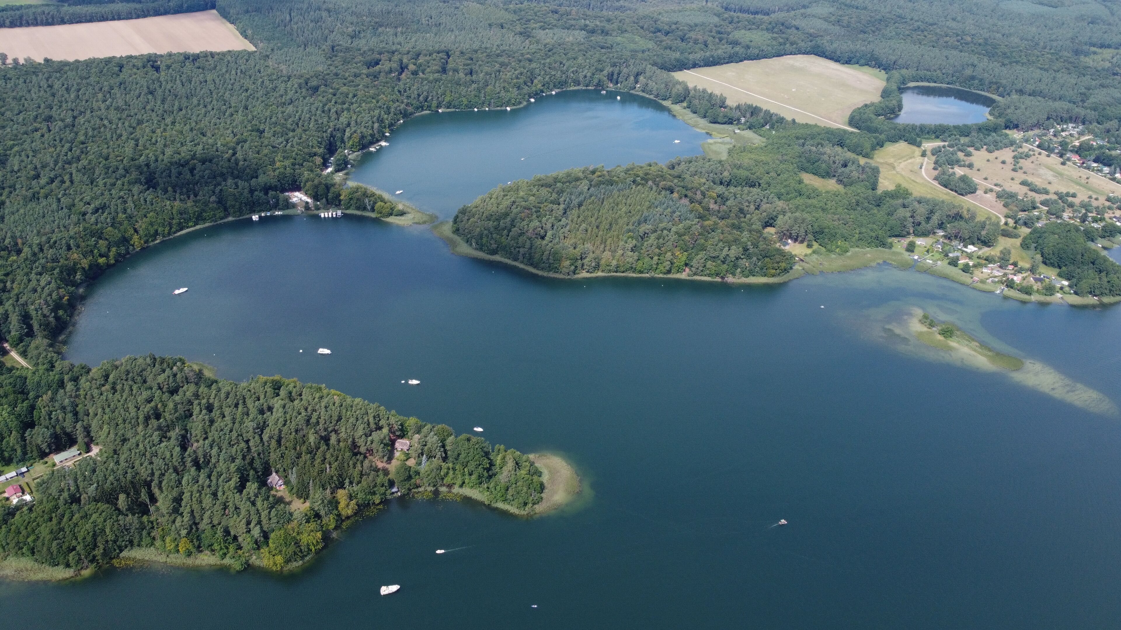 A large lake surrounded by dense forests and small islands.